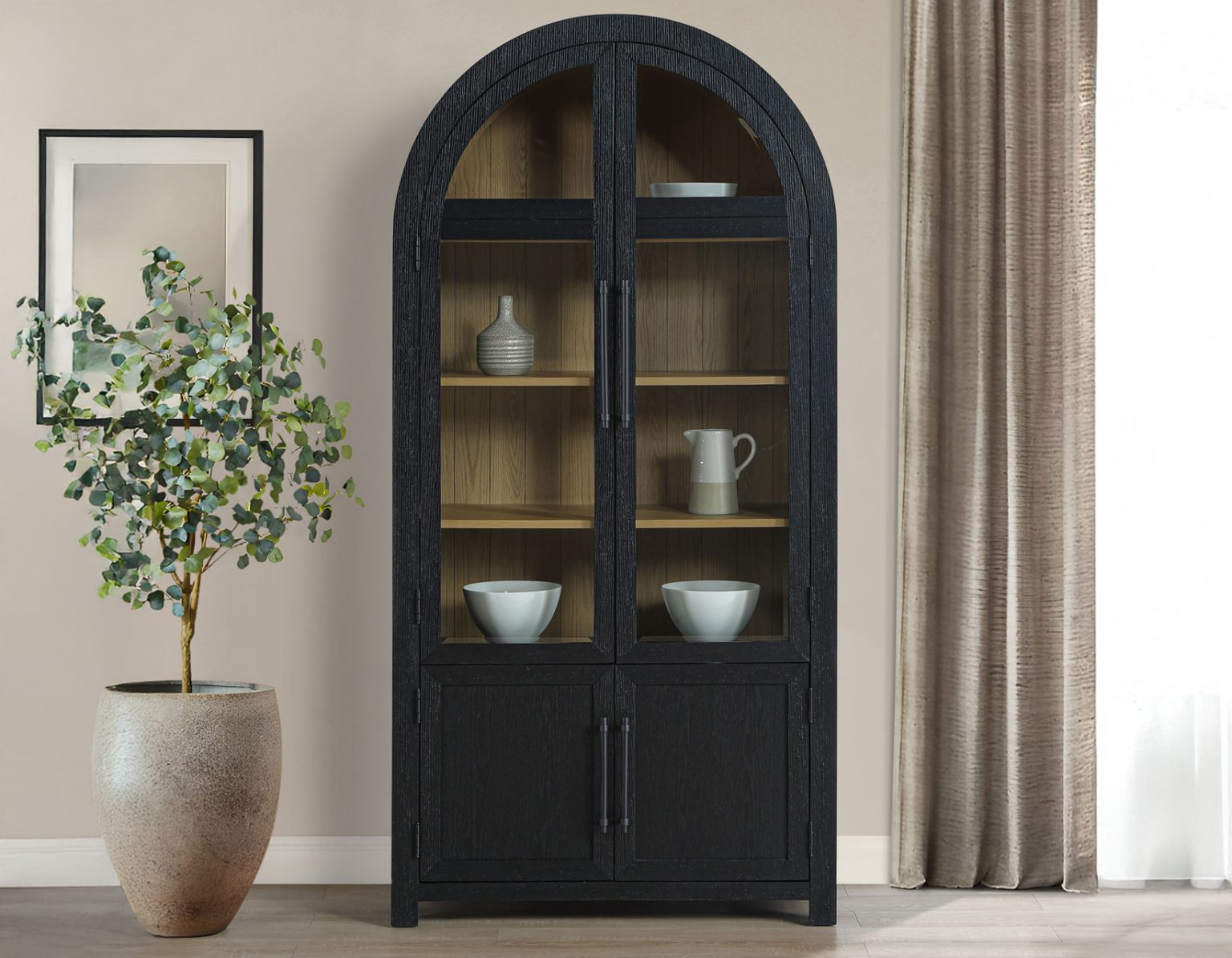 Magnolia curio cabinet in black finish with weathered sand interior, arched glass doors, display shelving, and farmhouse-inspired design.